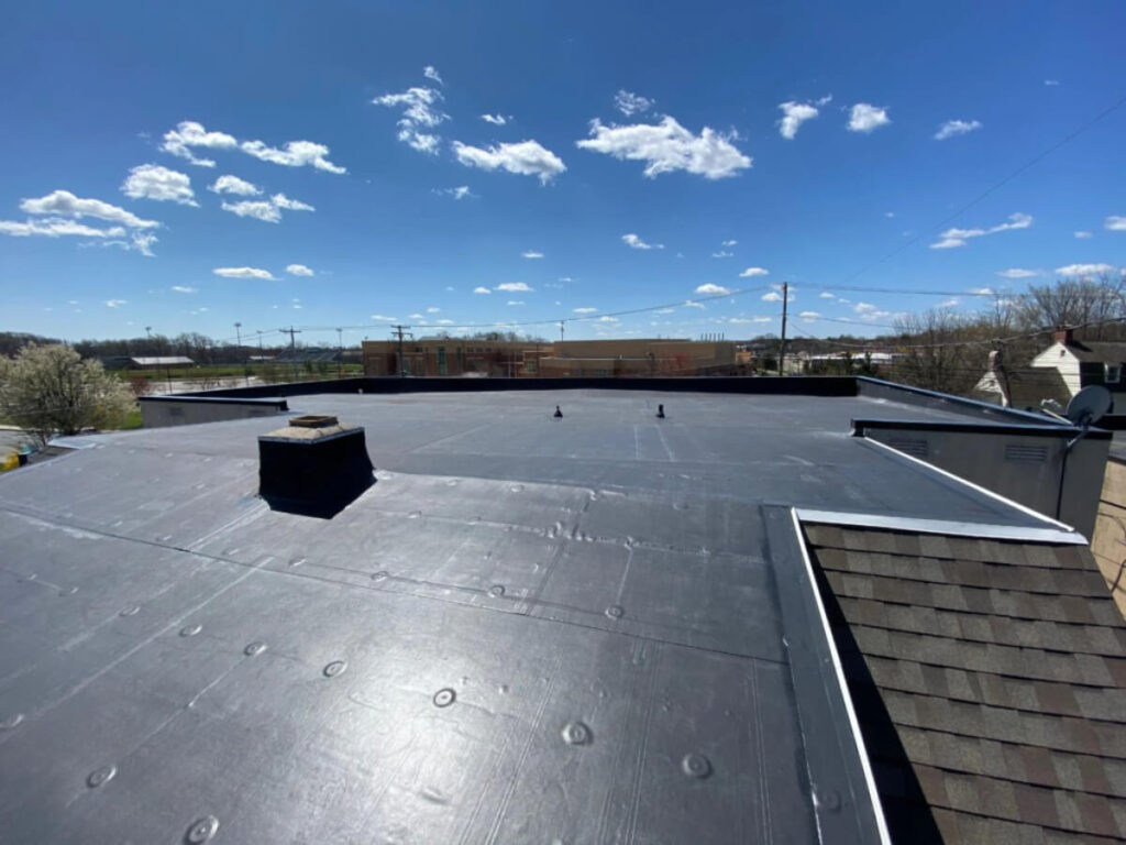 EPDM rubber flat roof installation on commercial building in Des Moines Iowa by Black Ridge Contracting